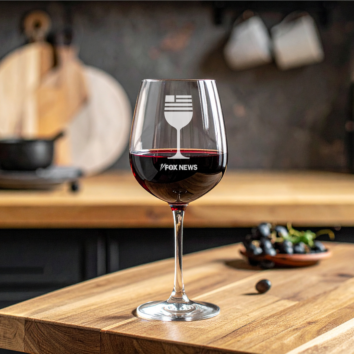 A crisp FOX News logo laser-engraved on a high-quality 17 oz stemmed wine glass, set in a clean and comfortable American home setting.