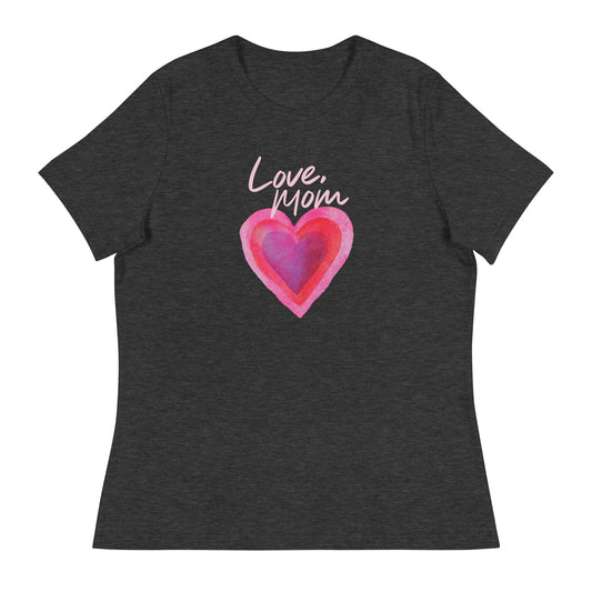 A modern American living room with warm lighting, featuring the FOX News Love Mom women's t-shirt neatly folded on a neutral surface.