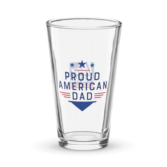 A patriotic FOX News Proud American Dad Pint Glass sitting on a clean wooden table in a suburban American home.
