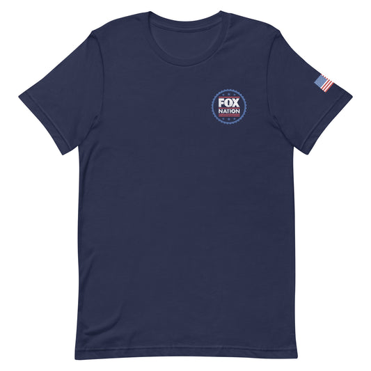 A man wearing the navy *FOX Nation* Badge T-shirt in a clean, suburban American backyard setting.