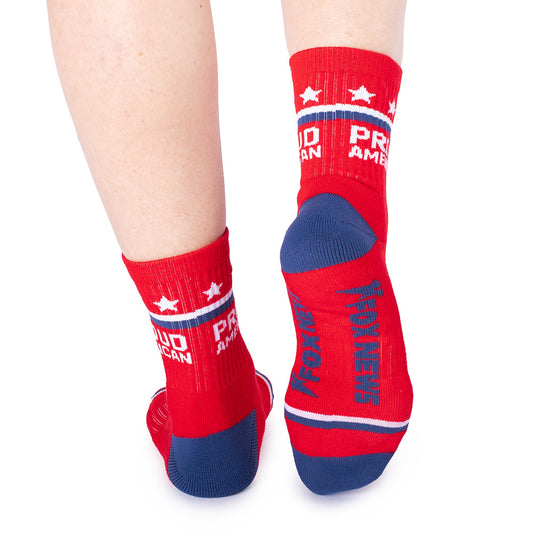 A pair of red *FOX News* Proud American Midi Socks displayed on a clean suburban American background.