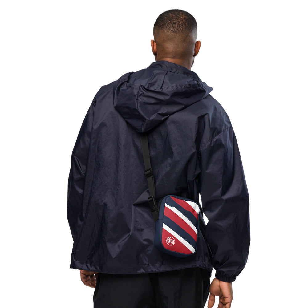 Detail shot showing the adjustable strap and secure zipper compartment of the FOX News crossbody bag.