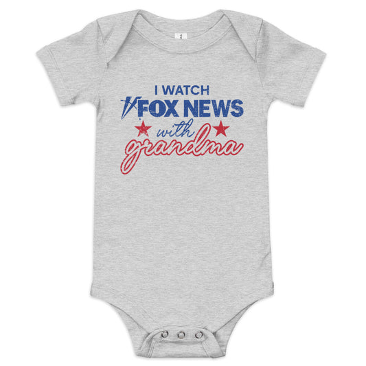 An infant wearing the white FOX News I Watch with Grandma bodysuit in a sunlit, clean American nursery.