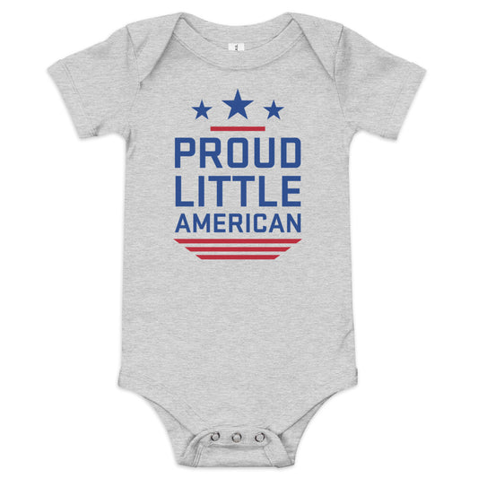 A baby wearing a grey FOX News Proud Little American bodysuit in a clean, bright American suburban nursery.
