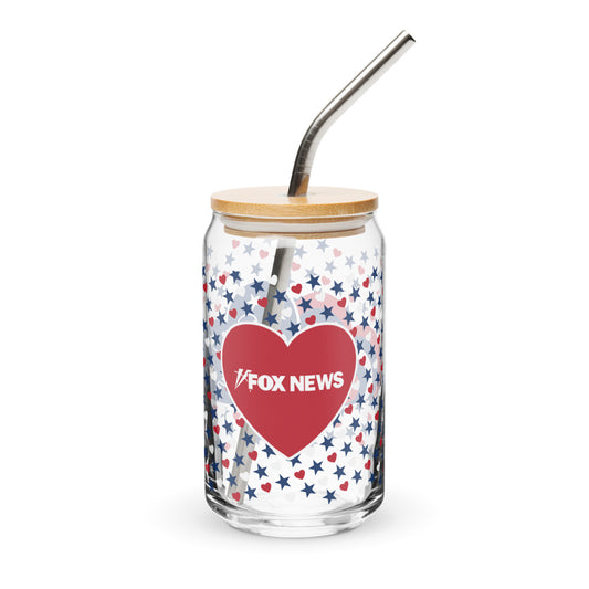 A 16 oz can-shaped glass featuring the FOX News Proud American hearts and stars design on a clean wooden table in a suburban American kitchen.