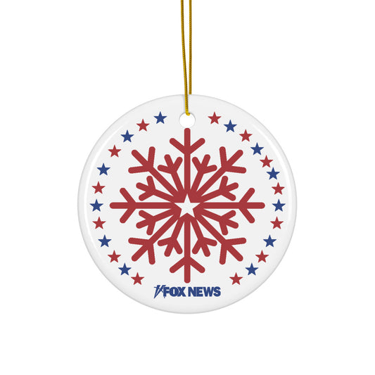 A circular white ceramic ornament featuring the blue FOX News logo and a snowflake pattern hanging in a modern American living room.