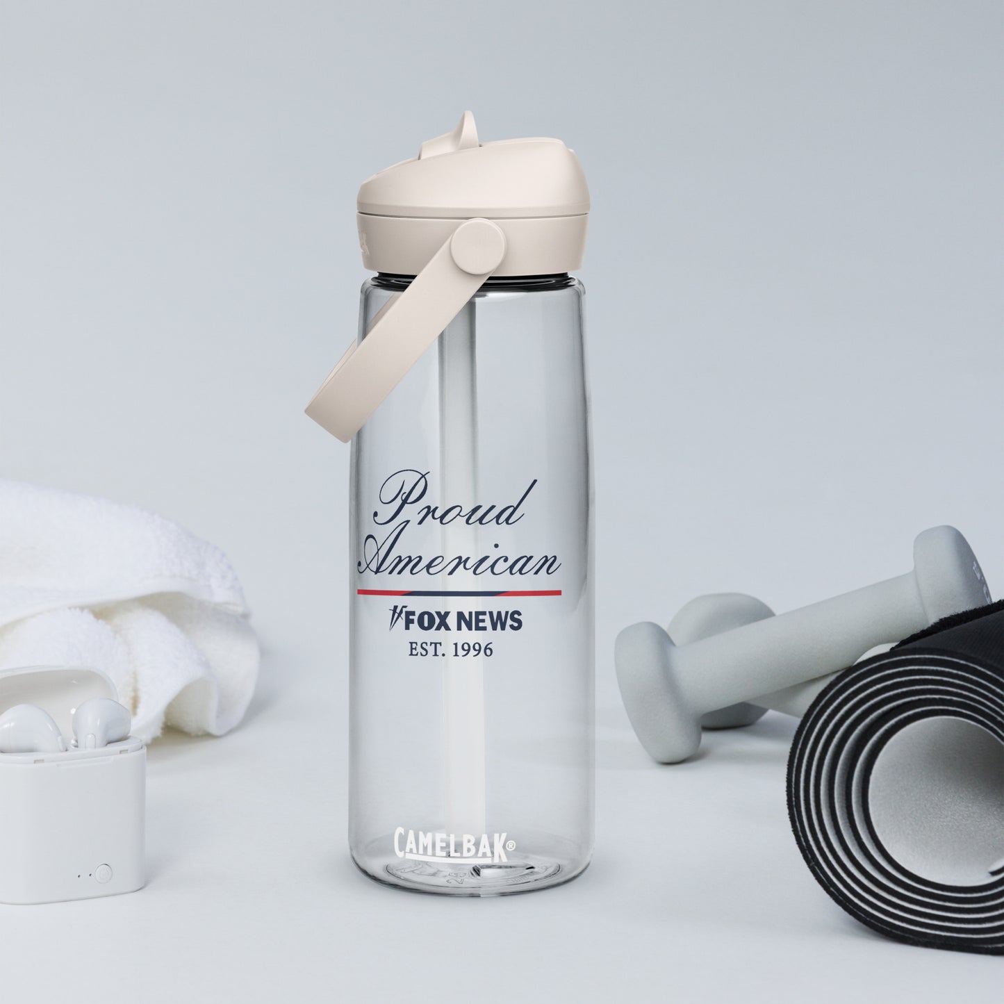 The FOX News Proud American water bottle sitting on a modern living room side table.