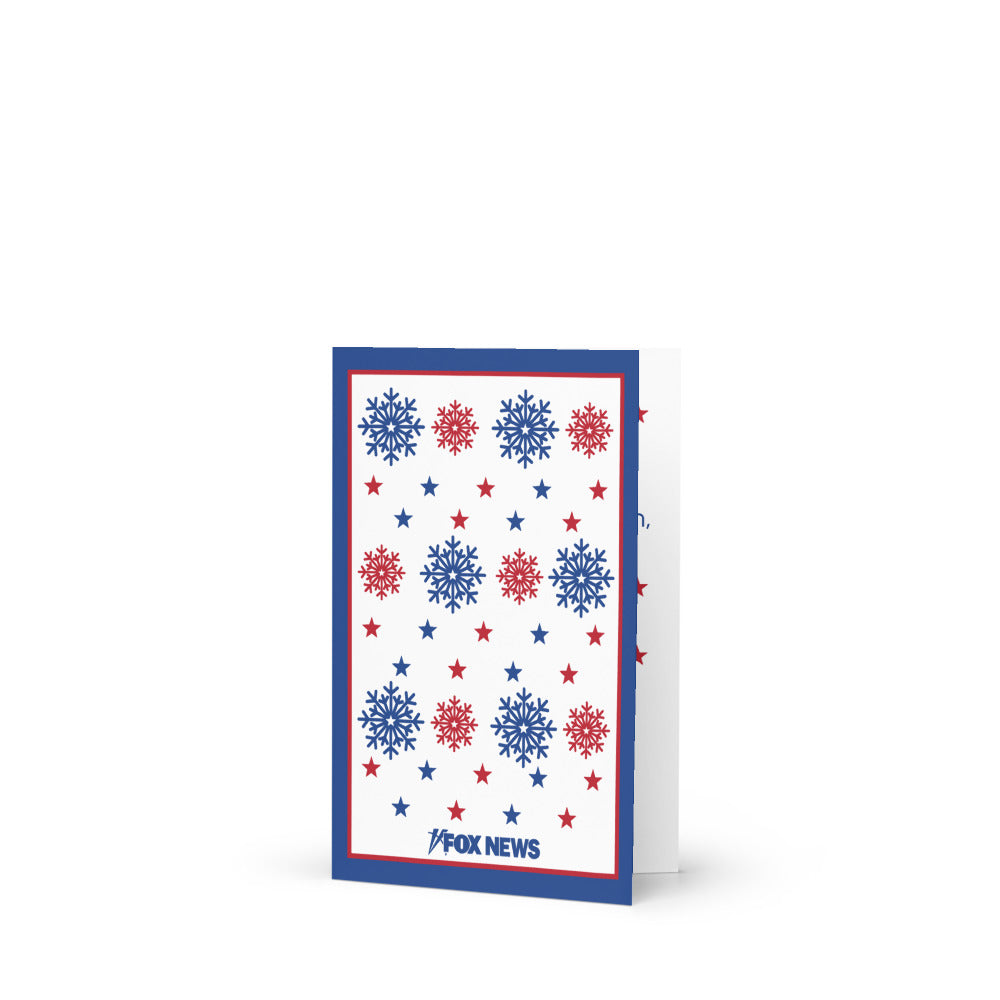 The FOX News Holiday Snowflakes Greeting Card paired with a white envelope in a comfortable suburban setting.