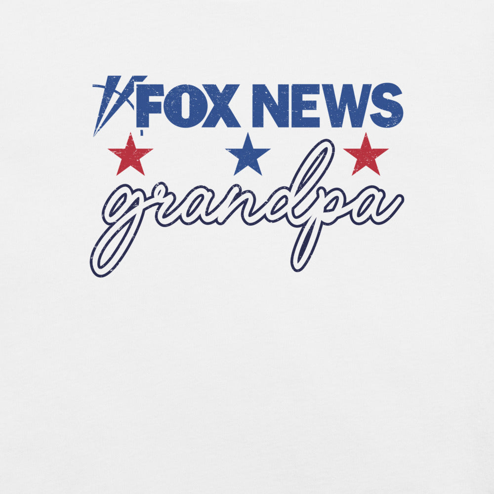 The FOX News Grandpa T-Shirt folded neatly on a wooden surface alongside a morning coffee mug.