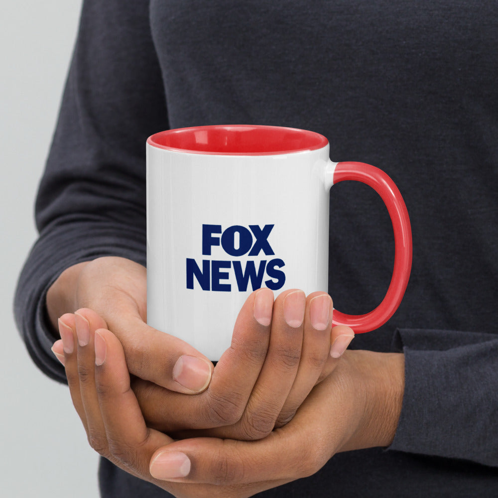 A FOX News hearts mug shown from the side to highlight the colored handle and interior contrast.