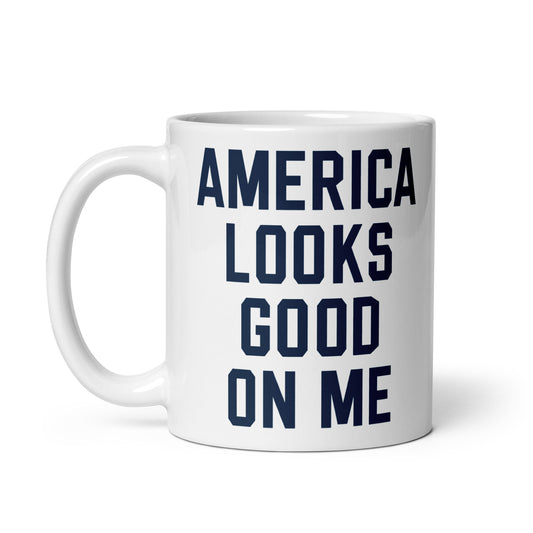 White ceramic coffee mug featuring the red, white, and blue FOX News logo and America Looks Good On Me text on the front