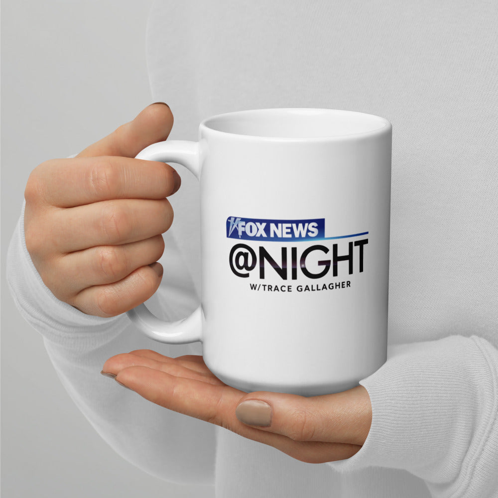 A side view of the 15oz Common Sense mug, showing the sturdy handle and official FOX News branding in a well-lit backyard setting.