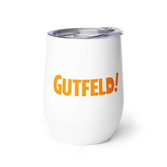 A modern American living room setting with a white Gutfeld! hearts wine tumbler resting on a polished wooden coffee table.