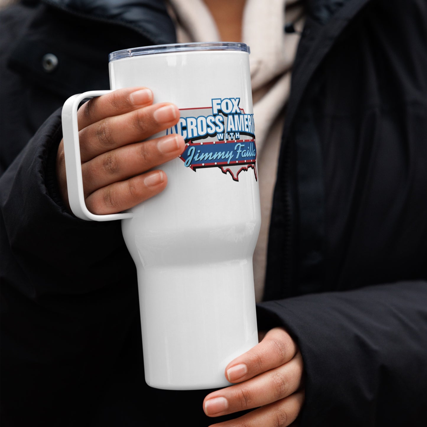 Jimmy Failla travel mug with handle displayed in a modern suburban home setting with the *FOX News* logo visible.