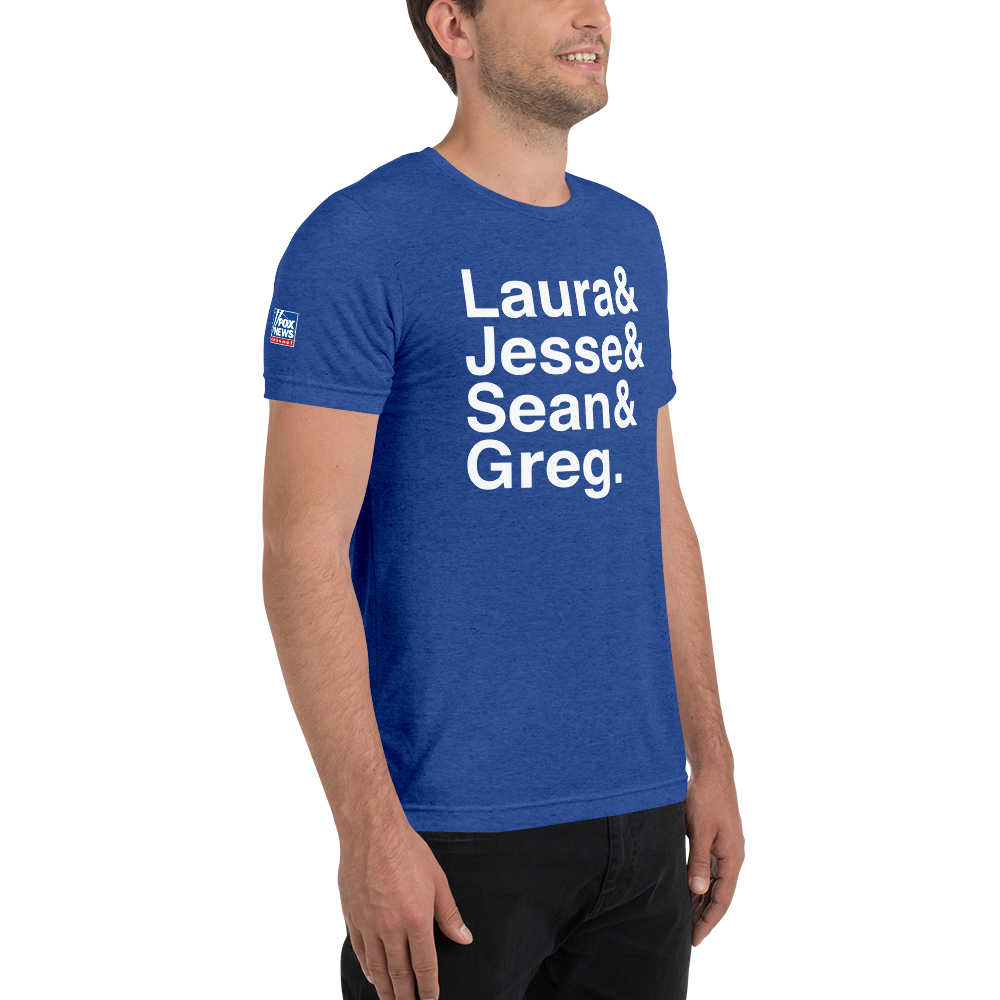 A comfortable unisex adult FOX News T-Shirt folded neatly on a wooden table in a classic suburban living room.