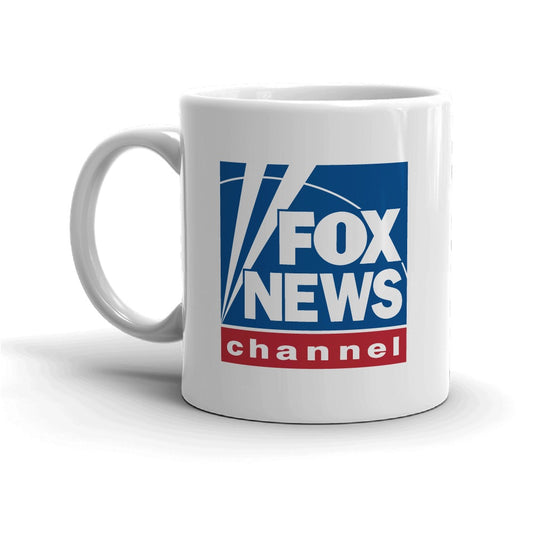 A modern American living room with morning sunlight streaming across a wooden coffee table displaying a crisp white ceramic mug featuring the FOX News logo.