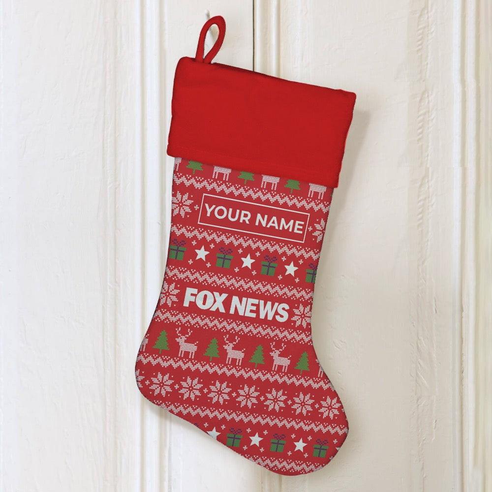 Close up of the crisp *FOX News* logo on a personalized red holiday stocking with white plush trim.