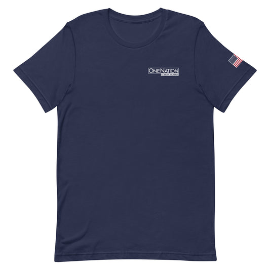 A front view of the FOX News One Nation T-shirt in Navy, displayed cleanly against a modern American living room background.