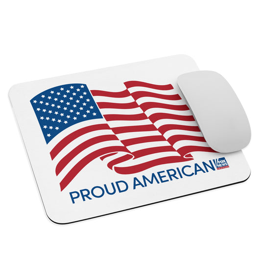Official FOX News Proud American mouse pad on a clean white desk in a modern American home office setting.