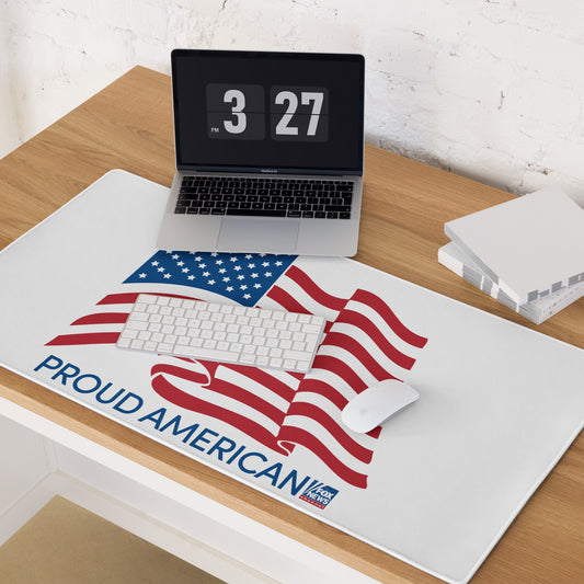 A wide FOX News Proud American desk mat featuring a white background and patriotic logo on a modern wooden desk in a clean home office setting.