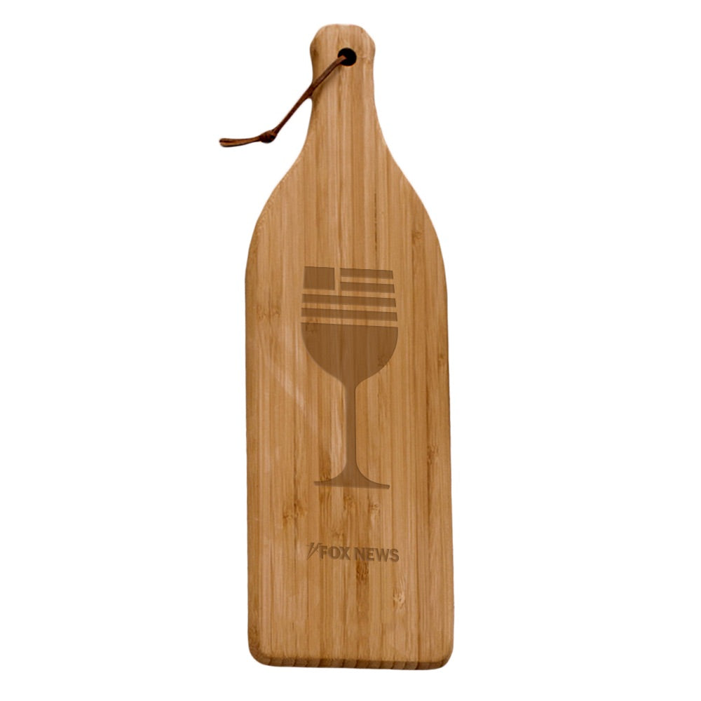 Detail shot of the durable bamboo grain and the professionally engraved *FOX News* logo on the wine bottle shaped cutting board.
