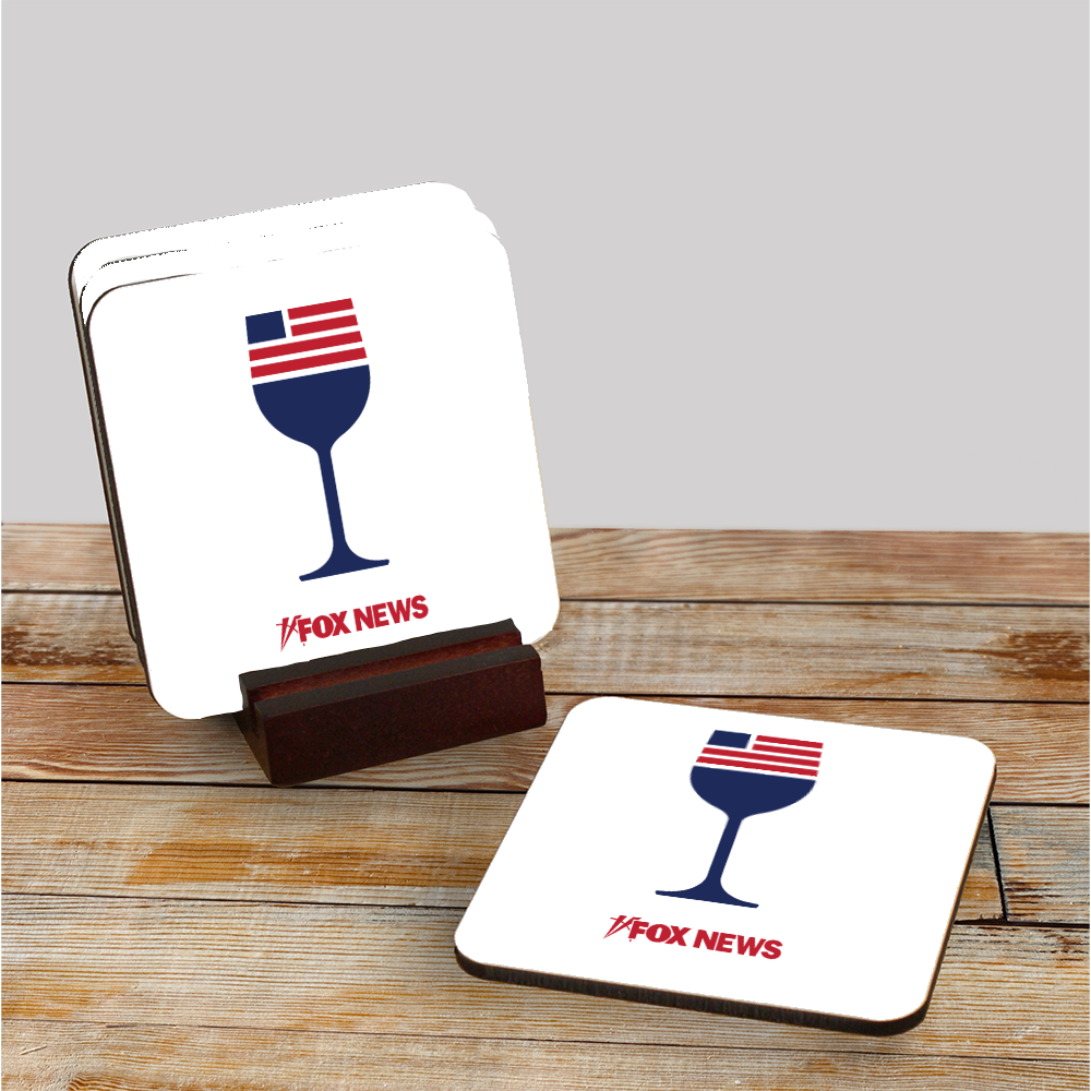 A set of 4 FOX News logo wine coasters neatly stacked inside a polished mahogany wood holder on a clean wooden table.