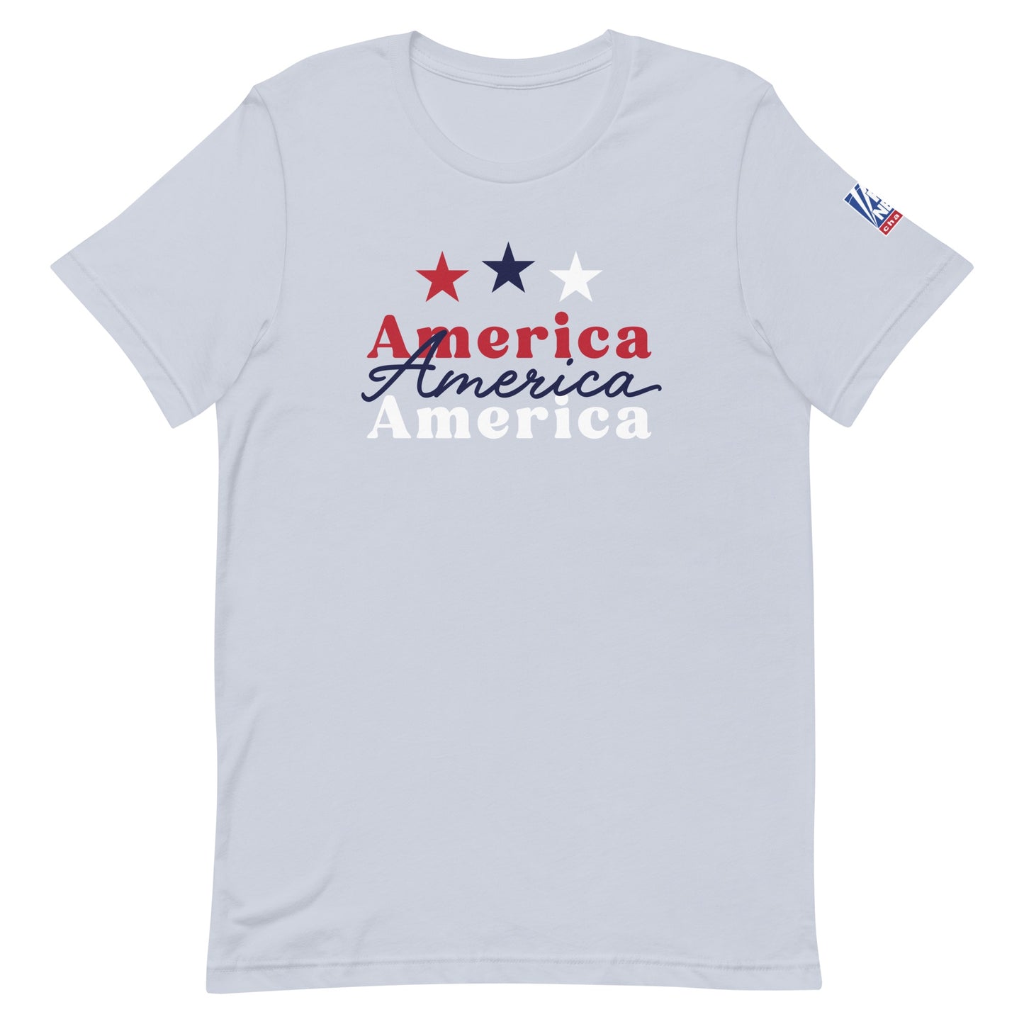A proud American man wearing the light blue FOX News America t-shirt in a modern, sunlit American living room setting.