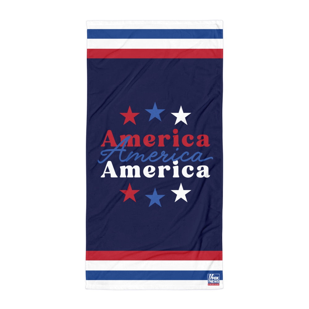 A bold FOX News America beach towel displayed in a bright American backyard setting.