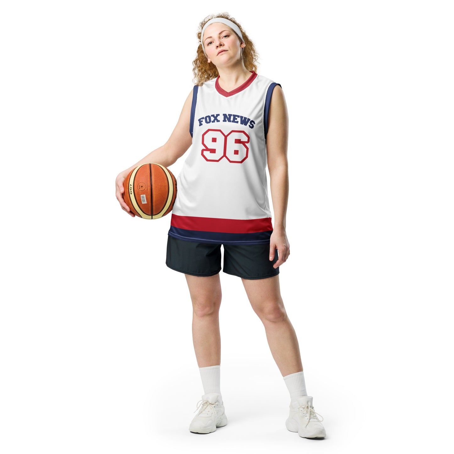 The *FOX News* basketball jersey laid flat on a wooden table, highlighting the vibrant red, white, and blue colors.