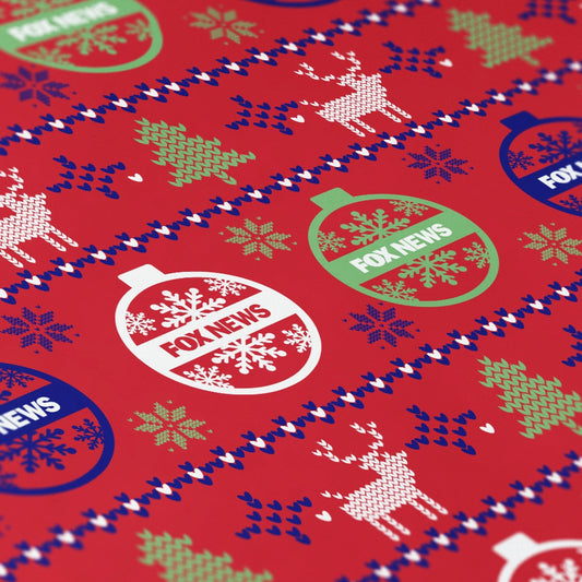 A roll of FOX News logo holiday wrapping paper displayed on a clean wooden table in a comfortable American home.-1