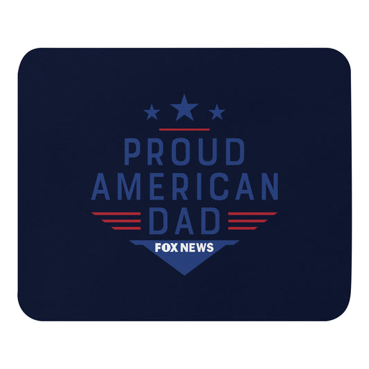 A FOX News Proud American Dad Mouse Pad sitting on a clean, modern American home office desk next to a computer mouse.