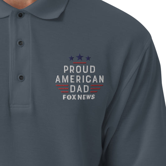A crisp, detailed close-up shot highlighting the embroidered Proud American Dad chest logo on the FOX News polo shirt.