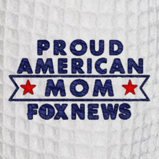 Close-up of the crisp embroidery reading Proud American Mom on the chest of the waffle-knit robe.