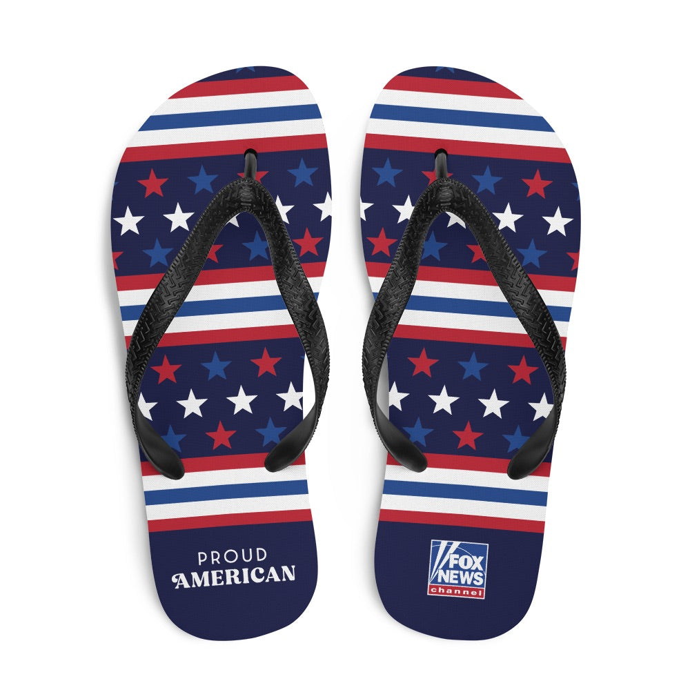 A pair of FOX News Proud American flip flops featuring a patriotic red, white, and blue design with the FOX News logo, set against a clean American backyard background.