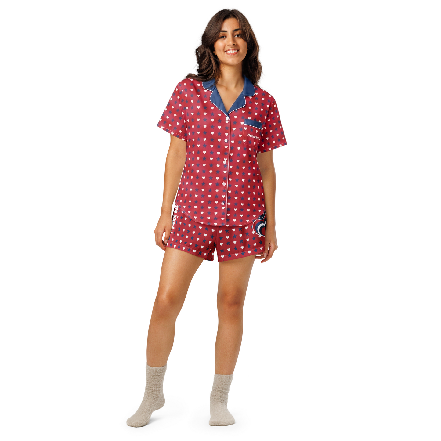A folded stack of FOX News patriotic sleepwear apparel styled in a warm, suburban home environment.