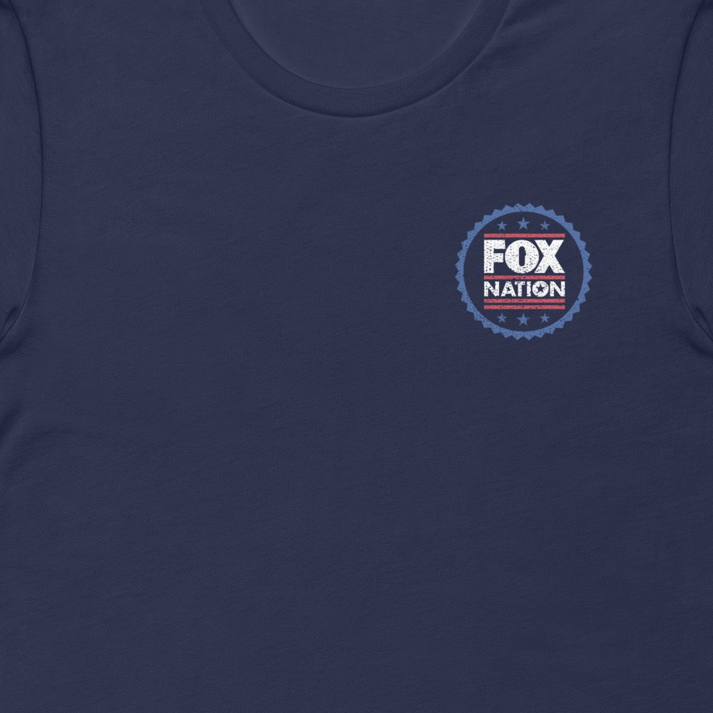 A close-up shot of the crisp white and red *FOX Nation* badge logo on the chest of the navy t-shirt.