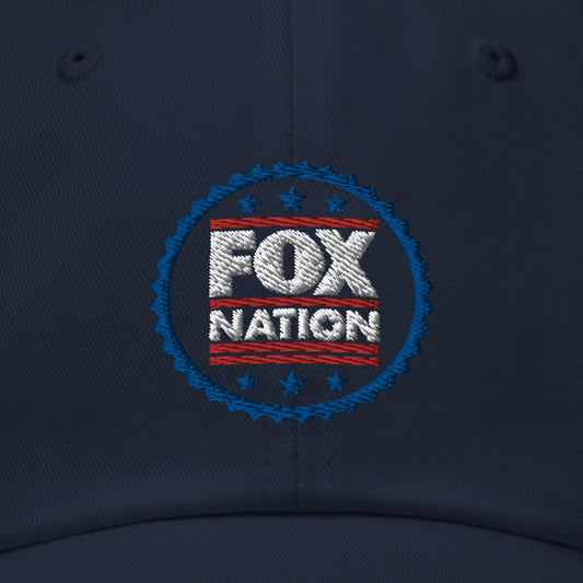 Close-up of the crisp, high-quality FOX Nation logo badge embroidered on the front of a navy blue baseball cap.