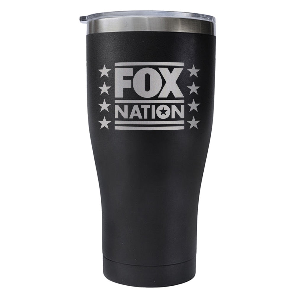 The 20 oz matte black FOX Nation tumbler held by a person in a casual outdoor setting.