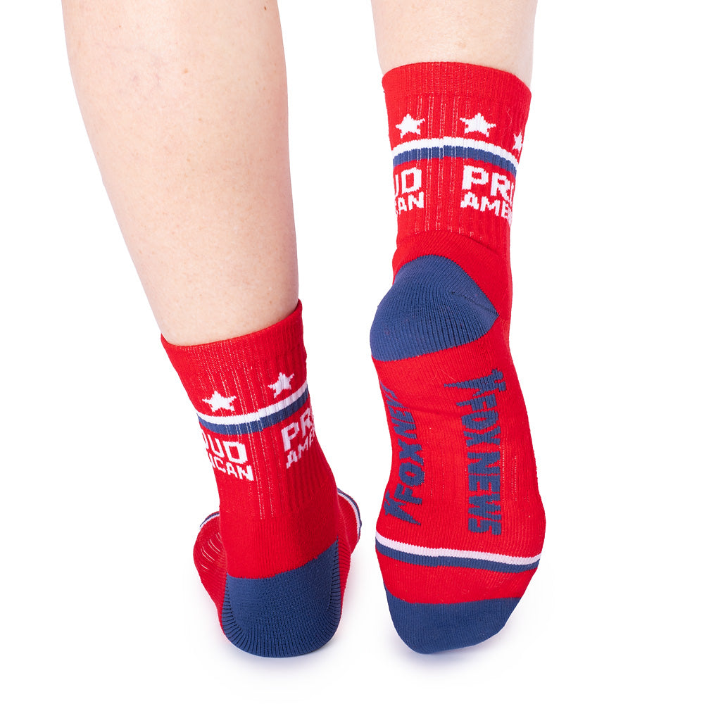 A pair of red *FOX News* Proud American Midi Socks displayed on a clean suburban American background.