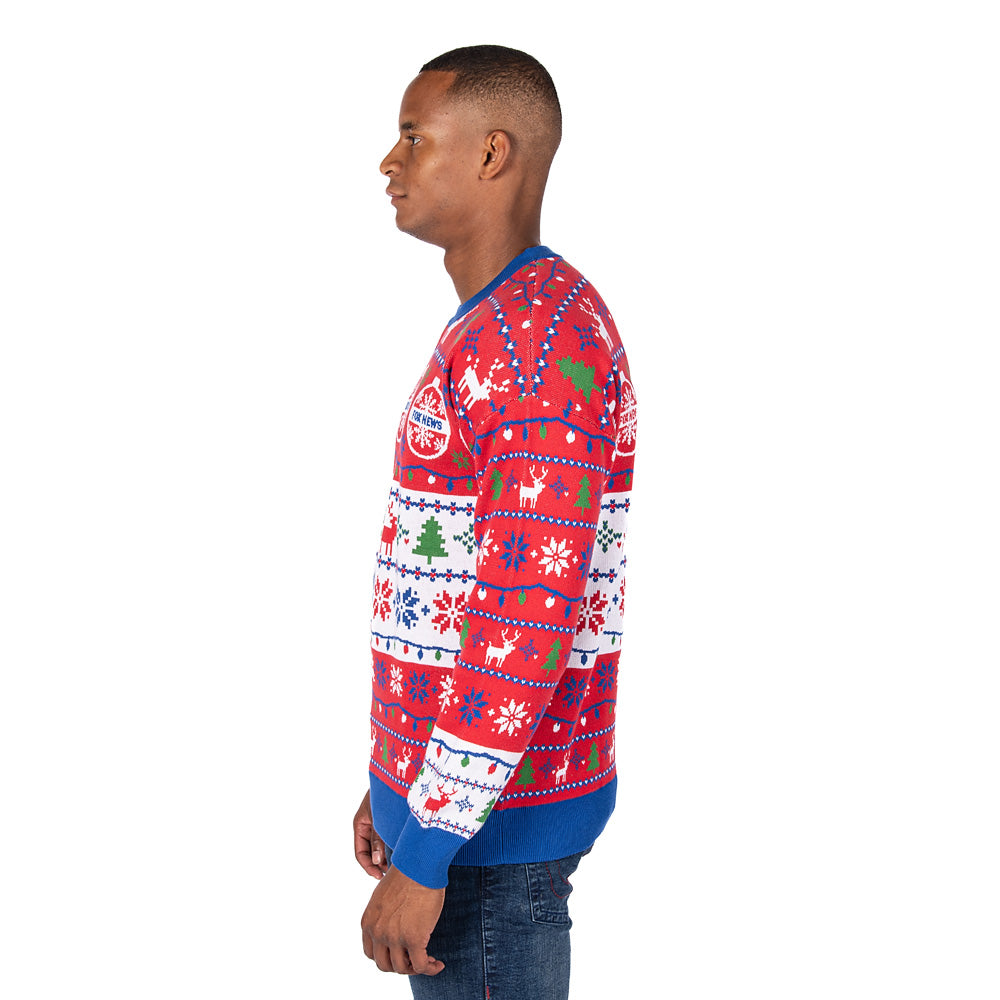 A flat-lay view of the FOX News Knit Holiday Sweater paired with winter accessories on a rustic wooden surface.