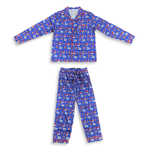 A man wearing *FOX News* Holiday Men's Pajamas in a modern American living room setting near a fireplace.