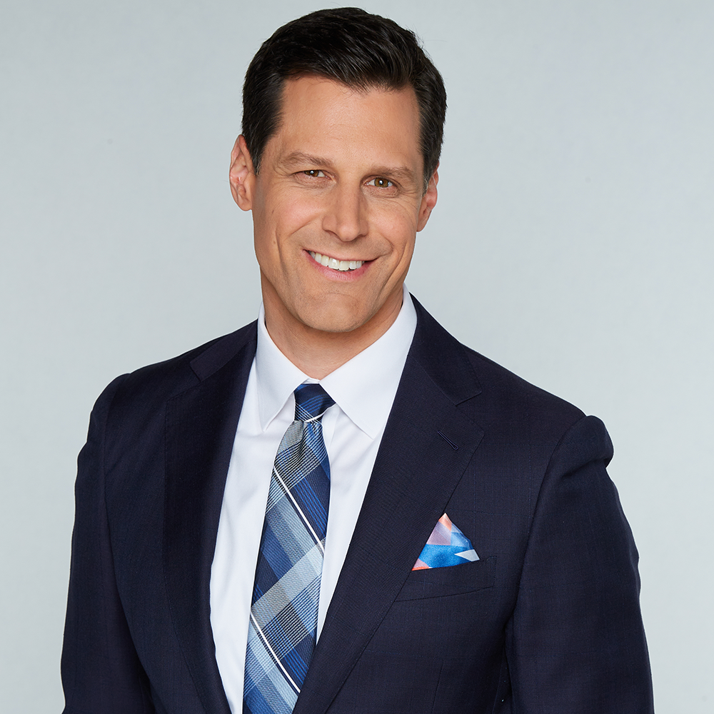 A crisp FOX News American Flag Pocket Square displayed in a formal suit jacket pocket in a professional American office setting.