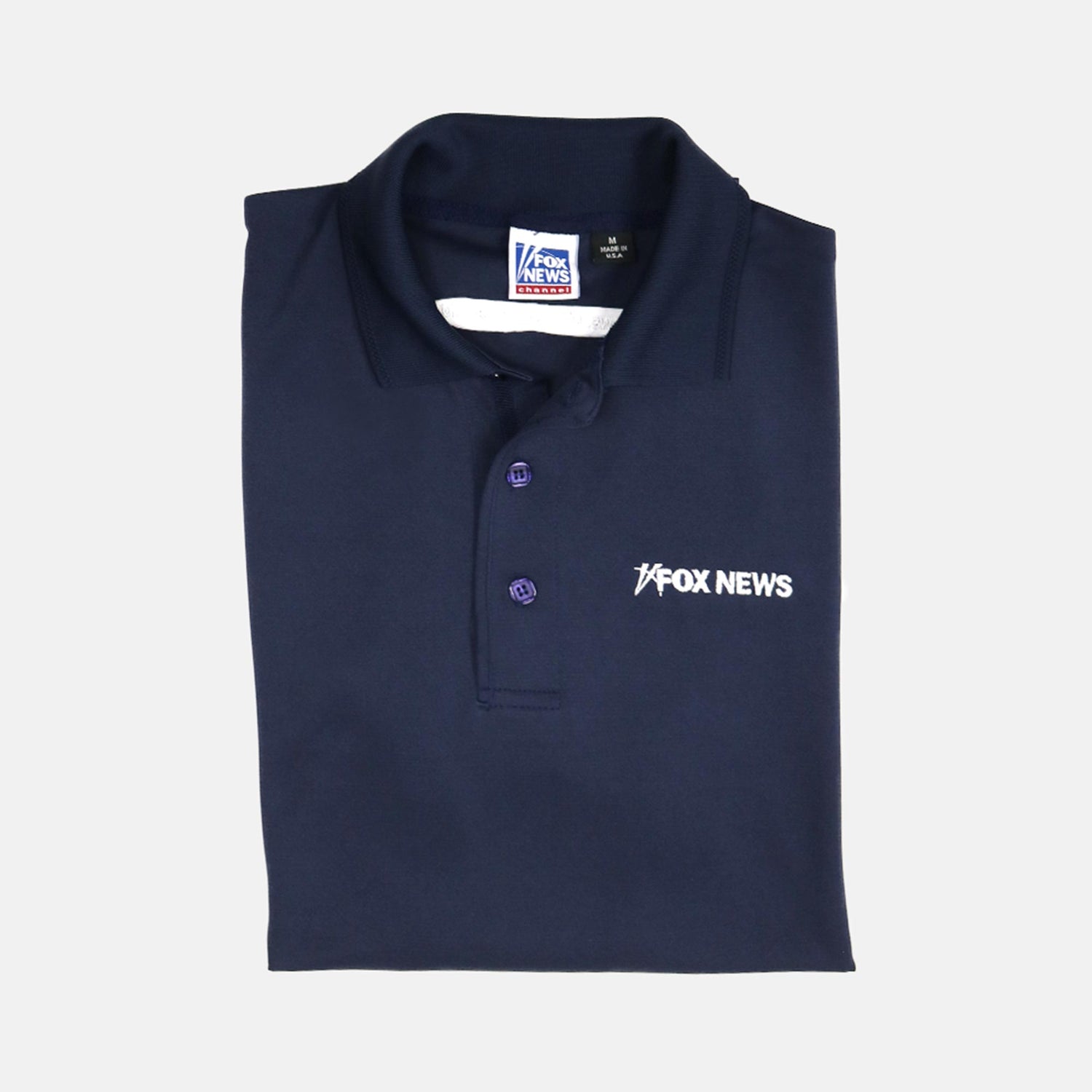 A man in a *FOX News* Men's Polo standing in a clean, suburban American living room.