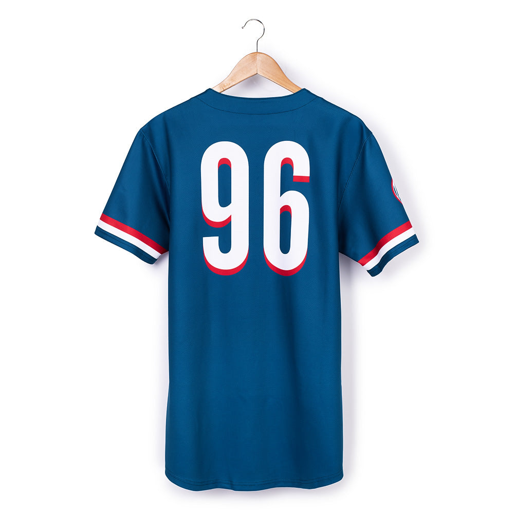 A man in a suburban backyard wearing the FOX News jersey while enjoying a morning coffee.