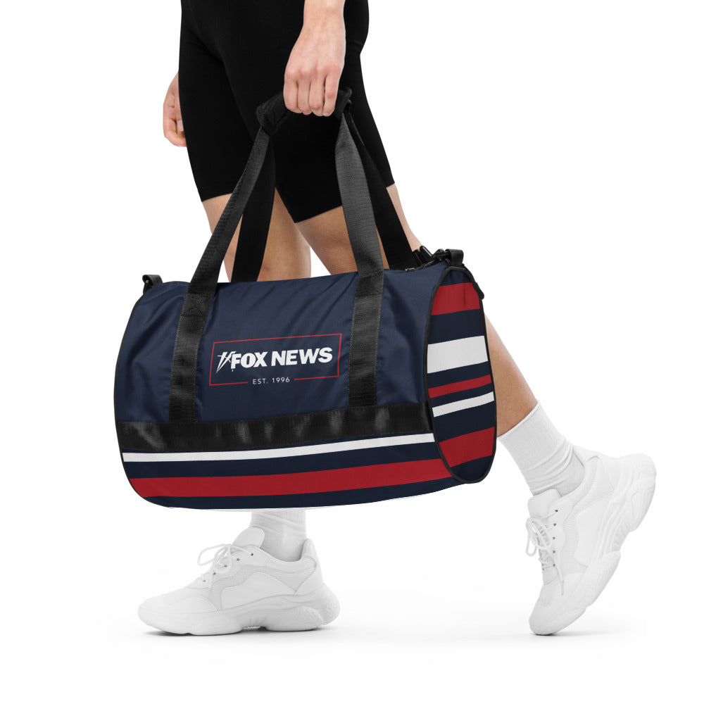 A lifestyle shot of the FOX News Logo Gym Bag packed and ready for travel.