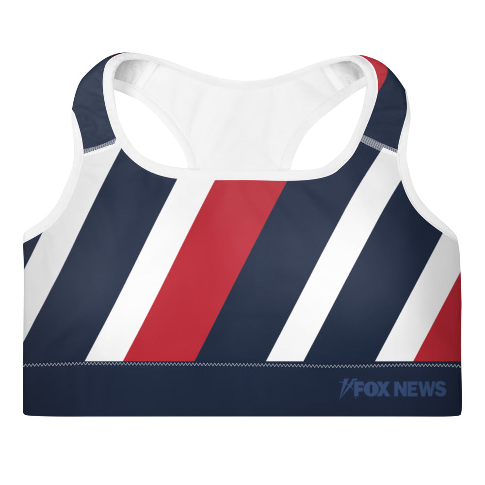 A woman wearing the FOX News Logo Women's Sports Bra in a modern American home gym setting.