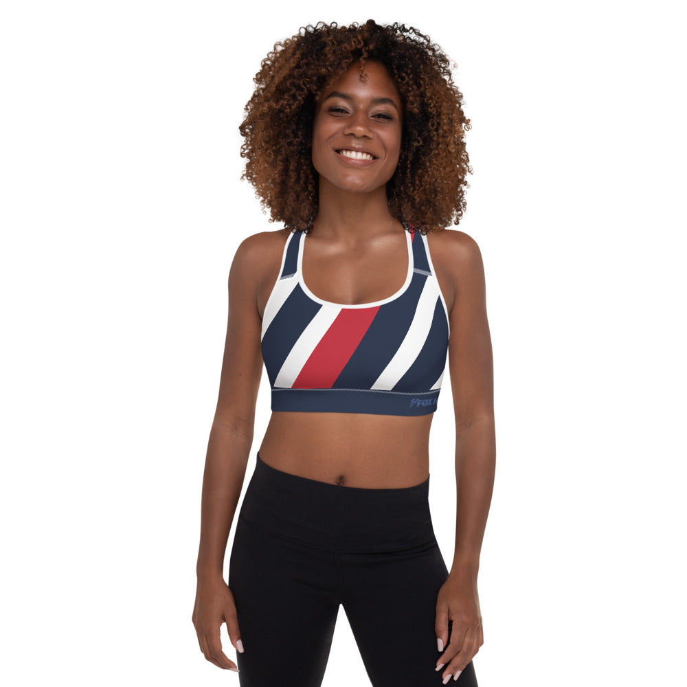 A lifestyle shot of the FOX News sports bra against a clean, suburban-style backyard background.
