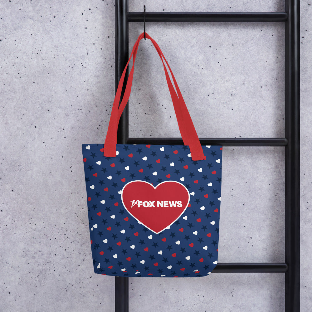 A woman carrying the FOX News Proud American tote bag while walking through a suburban American neighborhood.