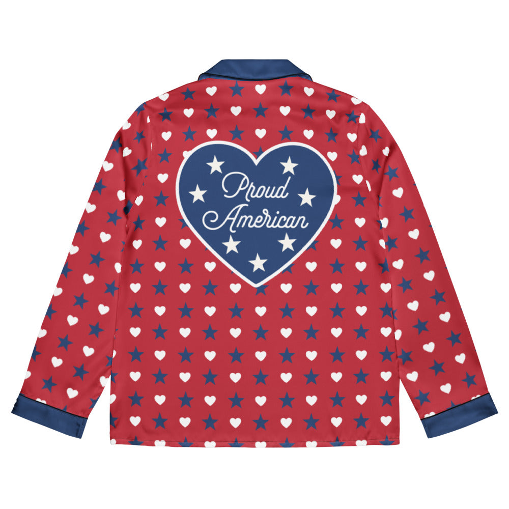 A cozy American living room setting featuring the FOX News Proud American Hearts And Stars Women Long Sleeve Pajama Top neatly folded on a comfortable armchair.