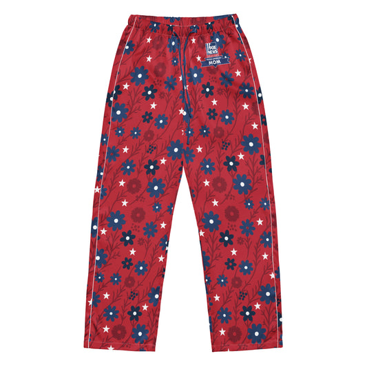 A woman wearing FOX News Proud American Mom Pajama Pants while relaxing on a sofa in a bright American suburban living room.